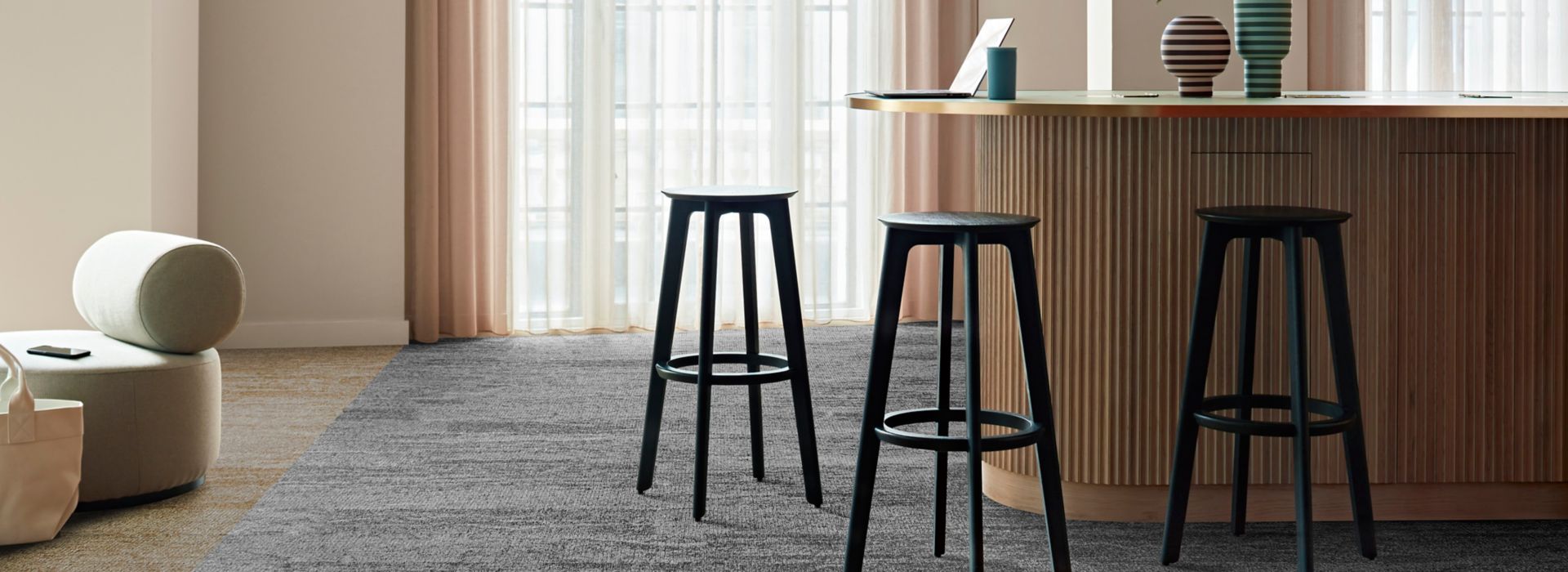 Interface Free Reign plank carpet tile in reception area with striped vases