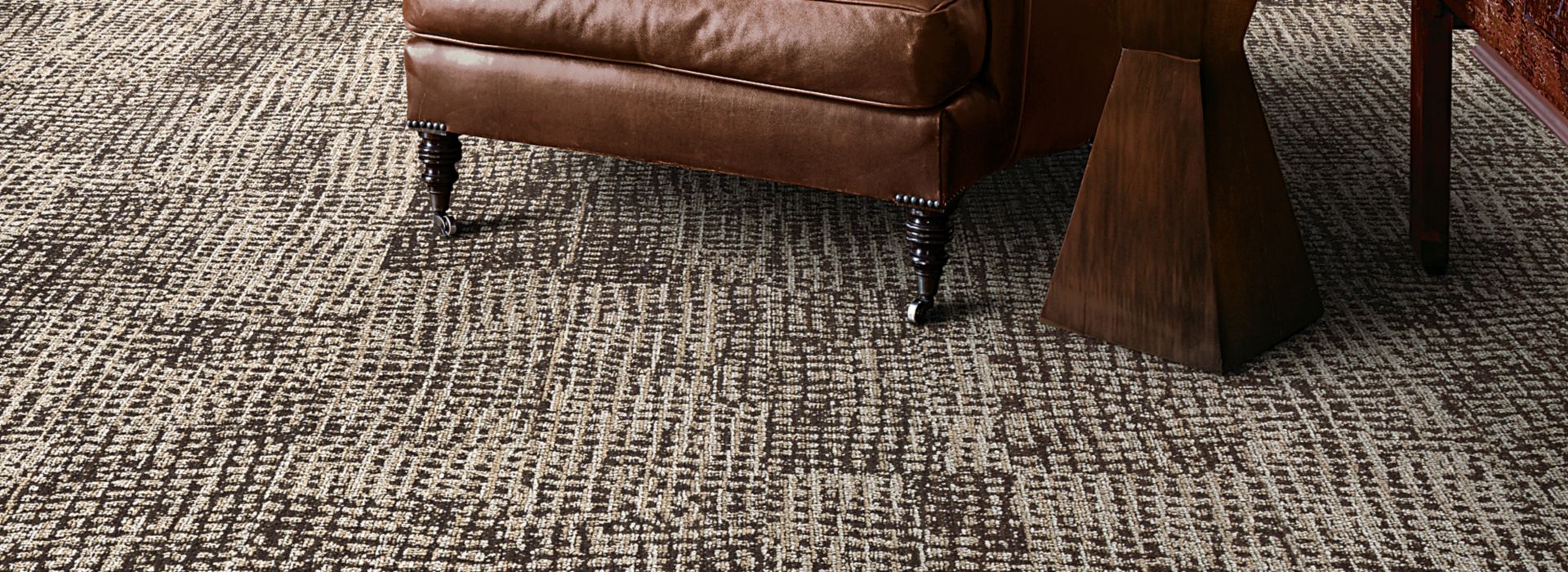 Interface GN160 plank carpet tile in lounge area by fireplace