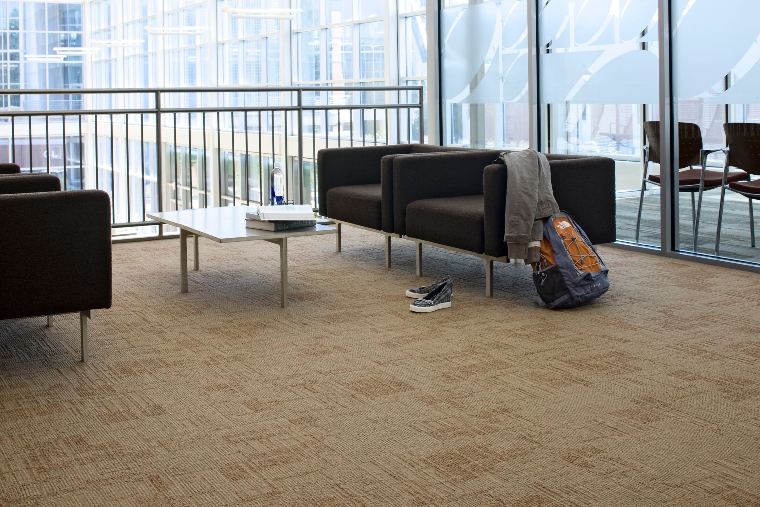 Interface Syncopation carpet tile in seating area with four chairs, short glass table, backpack and jacket image number 11