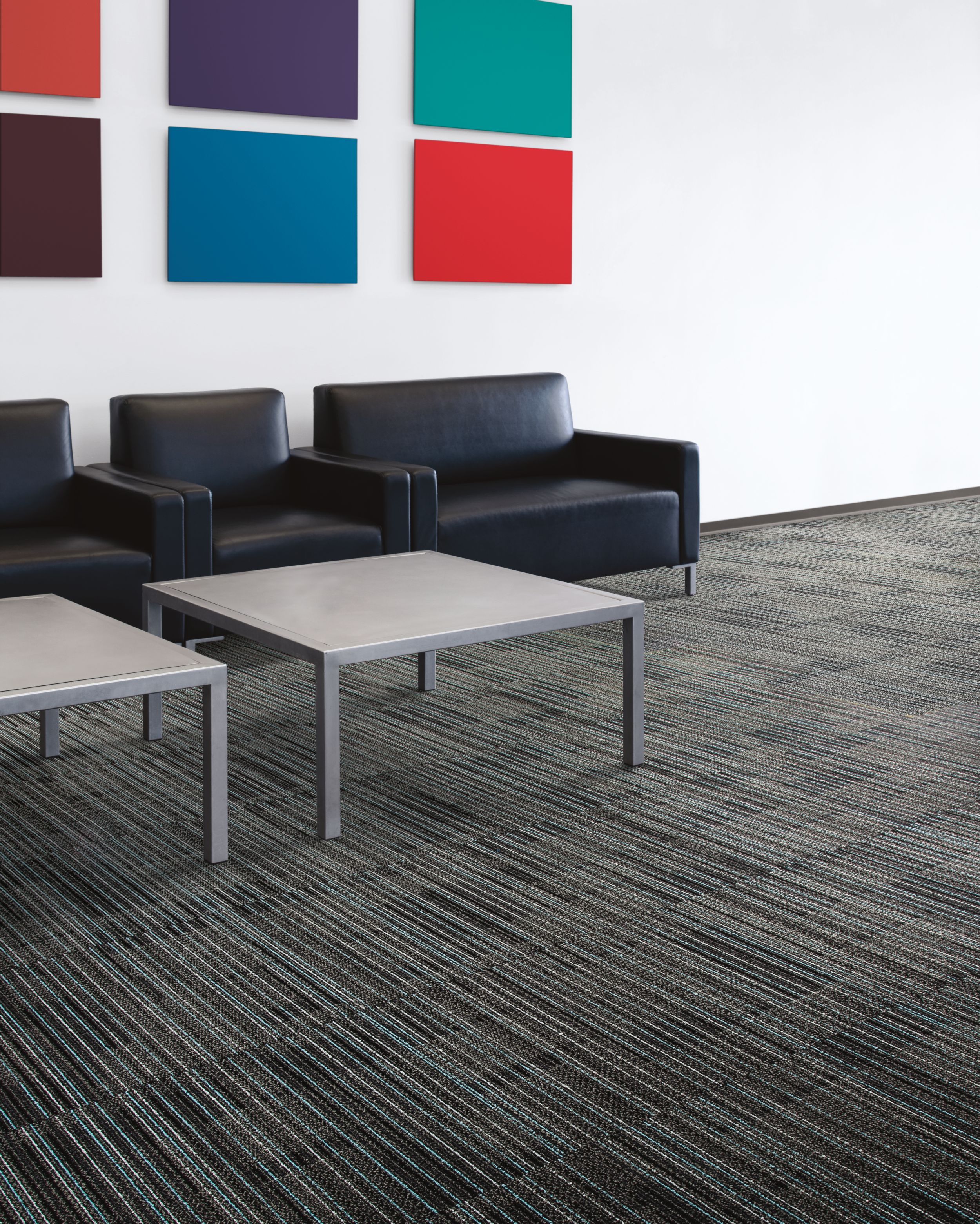 Interface Gather carpet tile in seating area with black chairs and colorful artwork image number 6