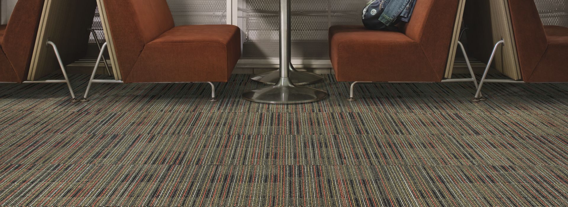 Interface Gather carpet tile with booths against large windows