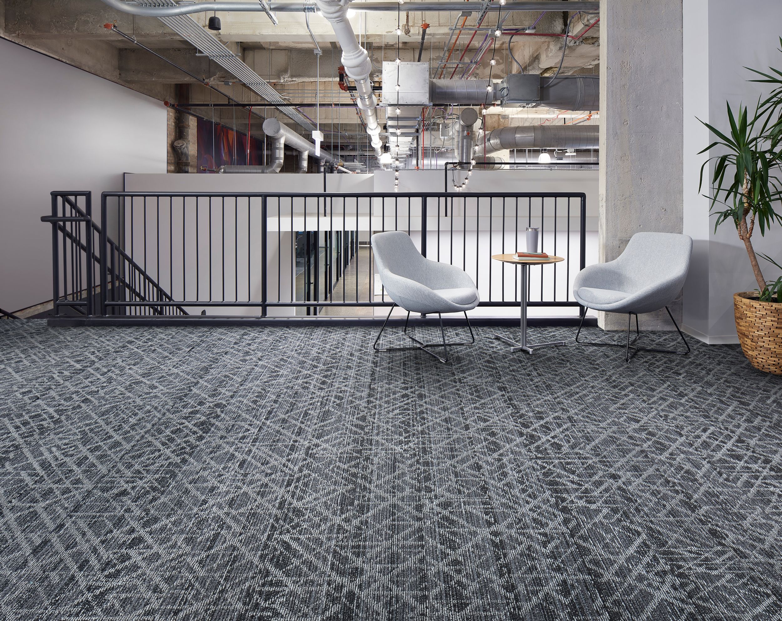 Interface Glisten plank carpet tile in seating area at stairwell with white chairs, small table and plant image number 3