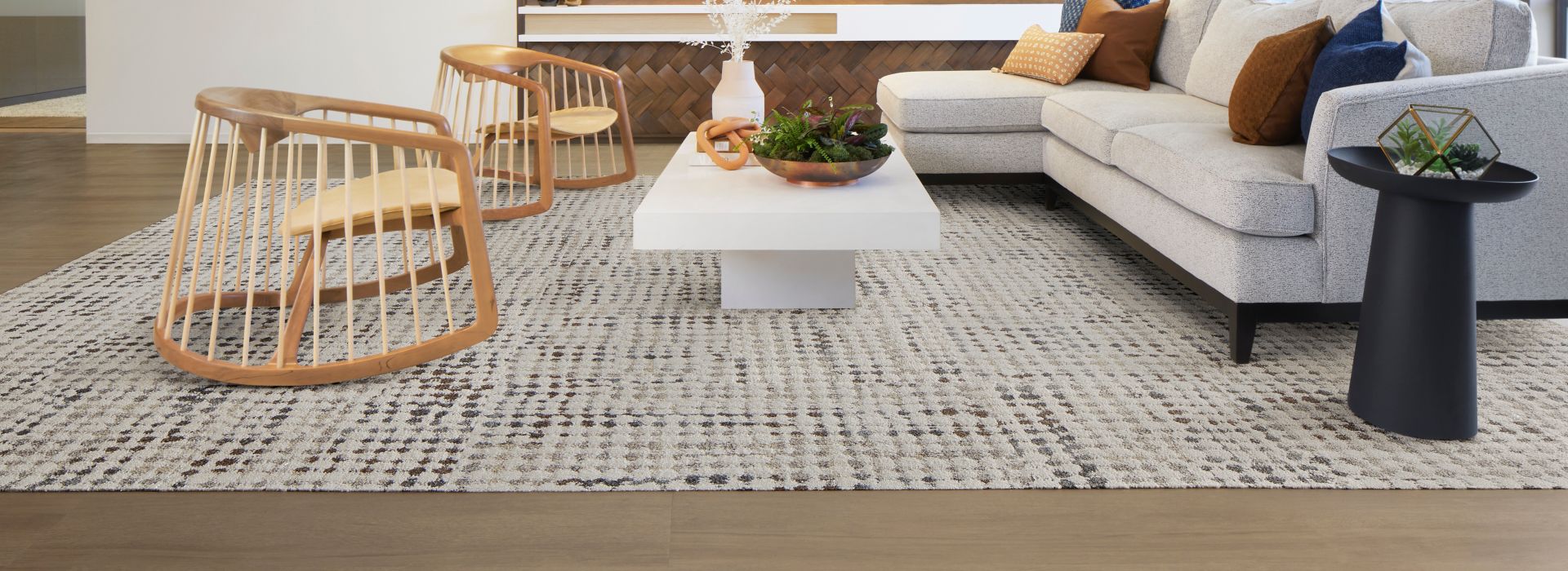 Interface Gossamer carpet tile with On Grain plank LVT in workplace lobby with exposed brick and modern furniture