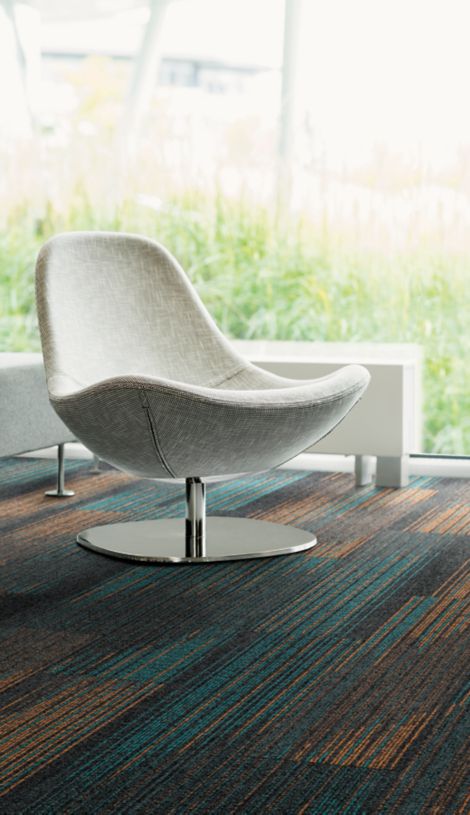 Detail of Interface Ground Waves Verse plank carpet tile with white chair