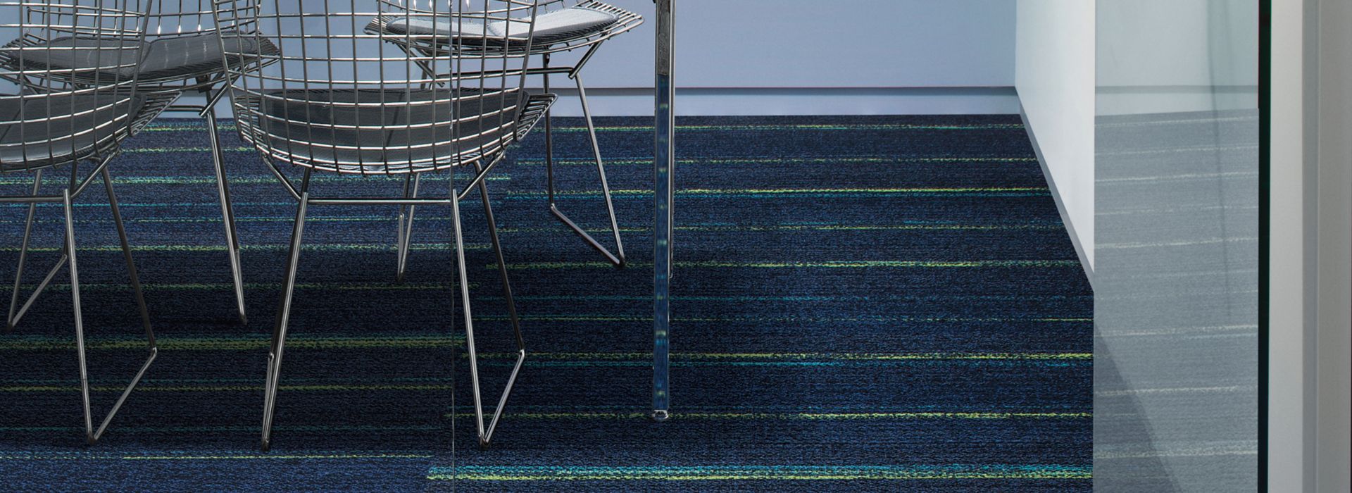 Ground Waves plank carpet tile in focus room with table, chairs and phone