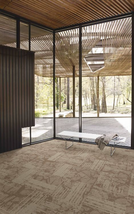 Interface Ground plank carpet tile against large glass windows with white bench