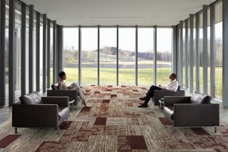 Interface Ground and Progression I carpet tile and Natural Stones LVT in multi-purpose room with walls of windows on three sides