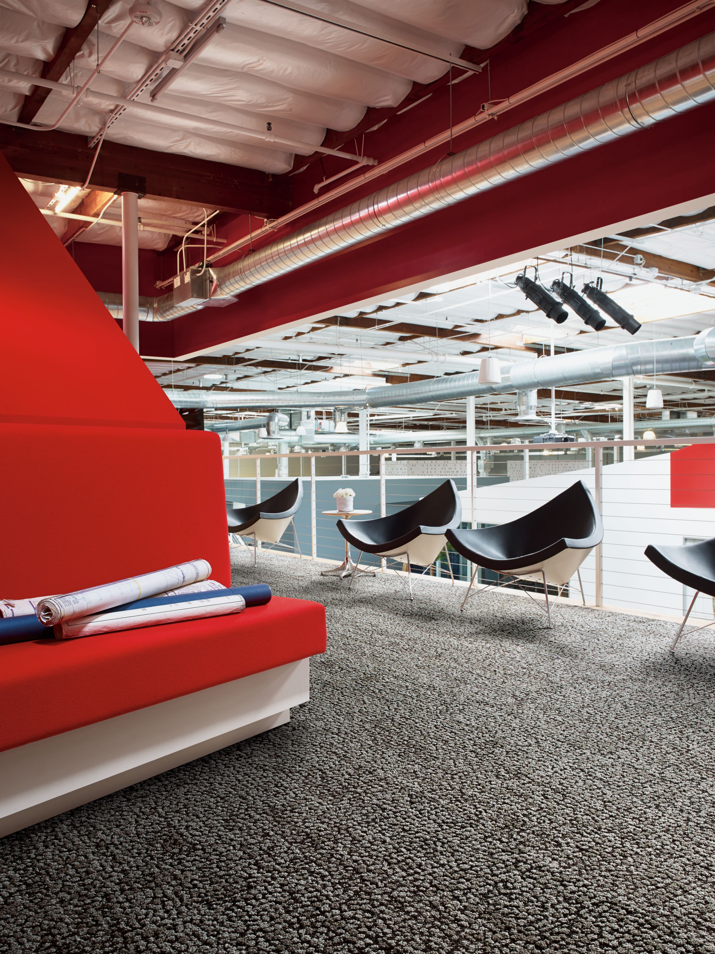 Interface HN840 plank carpet tile in upper level open space with red bench and black chairs image number 1