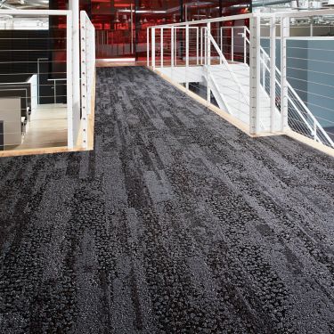 Interface HN850 plank carpet tile in upper level open stairwell with red glass meeting room in background image number 1