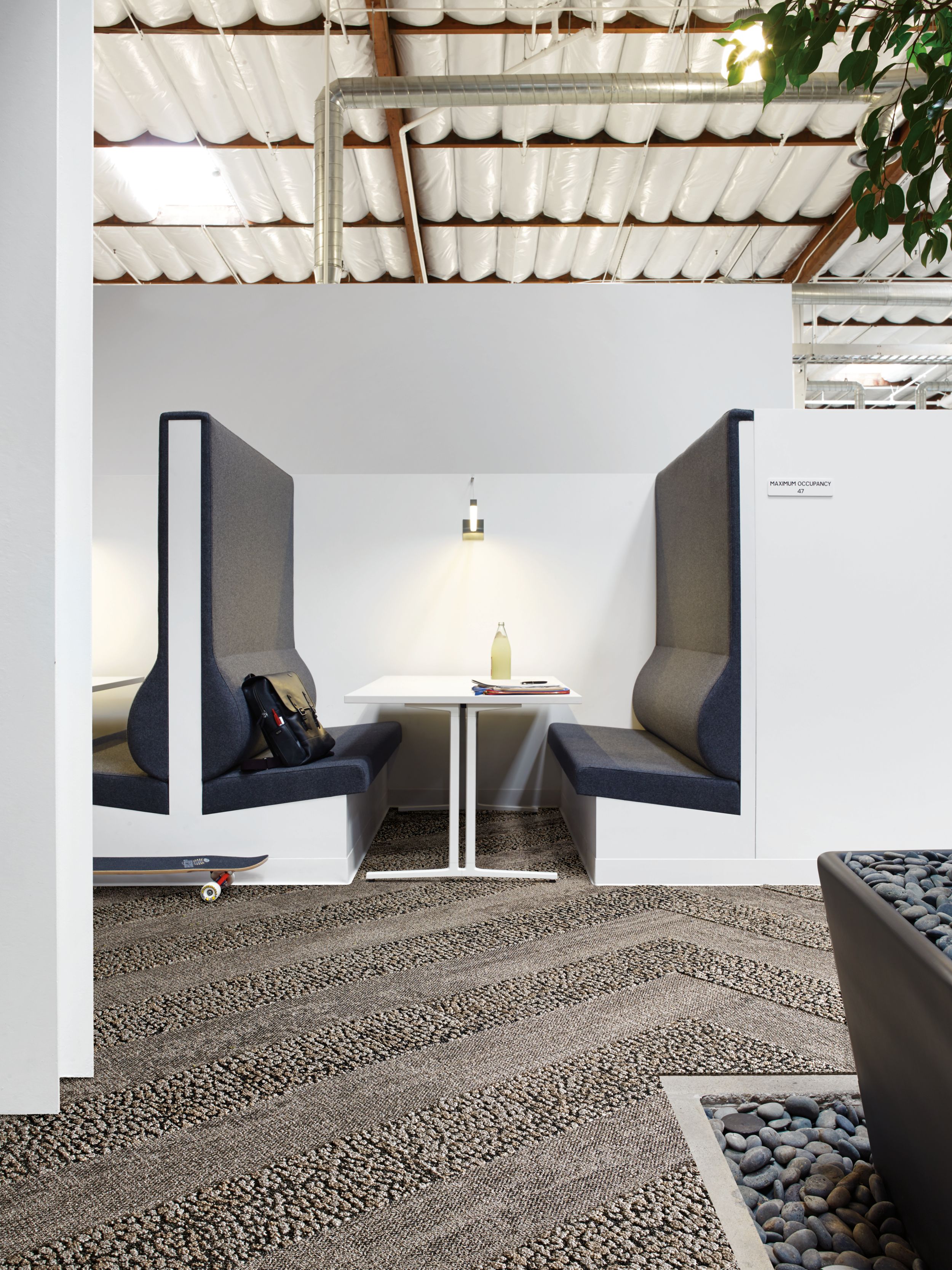 Interface HN820 and HN840 plank carpet tiles in white booth with blue upholstry image number 6