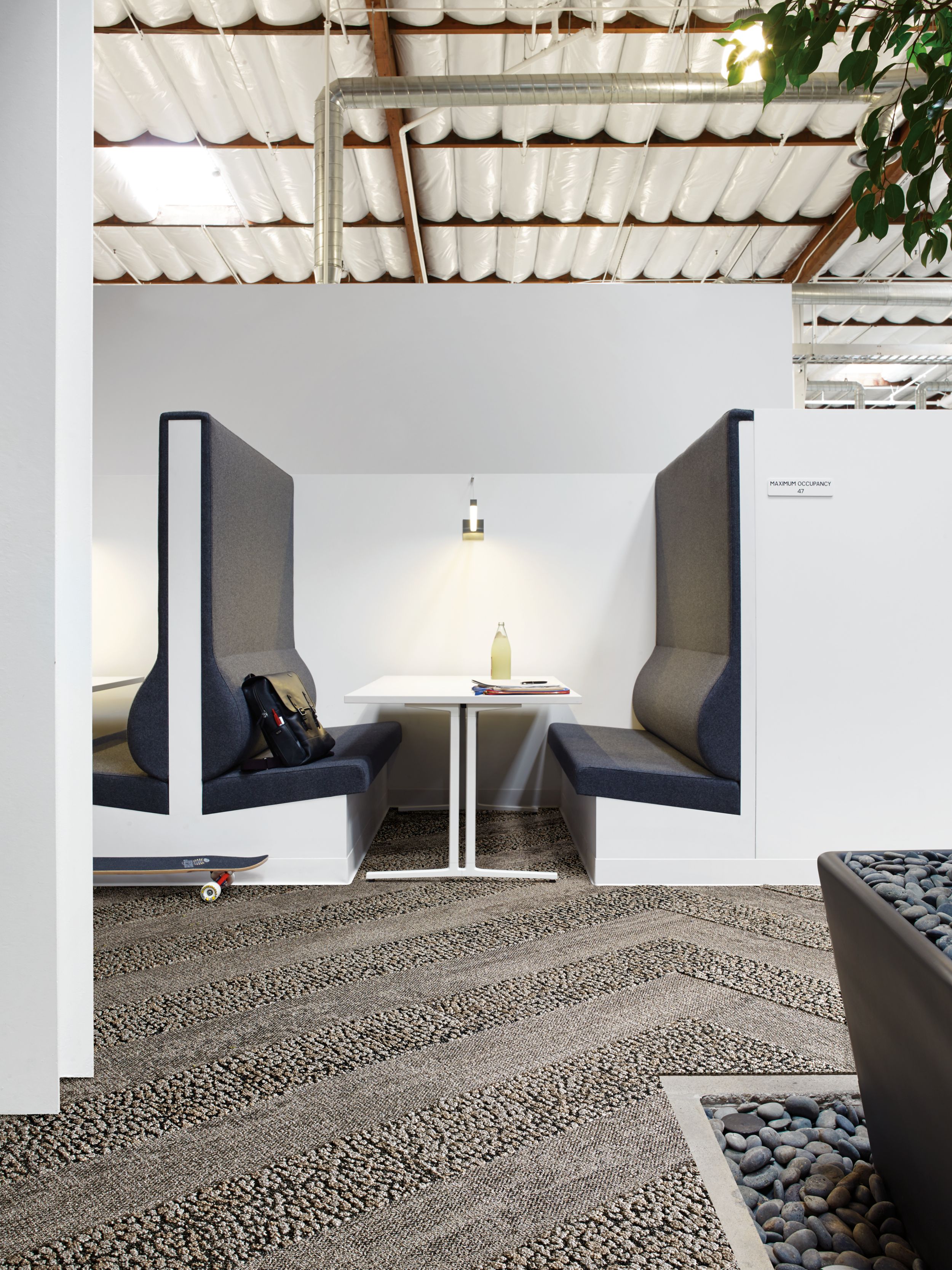 Interface HN820 and HN840 plank carpet tiles in white booth with blue upholstry image number 7
