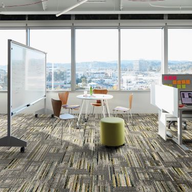 Interface Hard Drive plank carpet tile in collobaration space with whiteboard and small cubicle