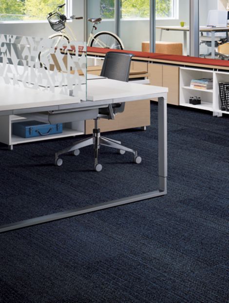 Interface Harmonize plank carpet tiles in workspace area with open desk, red covering on shelf and bike in background image number 6