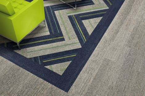 Interface Harmonize and Ground Waves plank carpet tiles with neon green chair