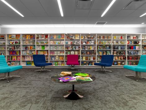 Interface B603 carpet tile in area with bookshelves and colorful chairs