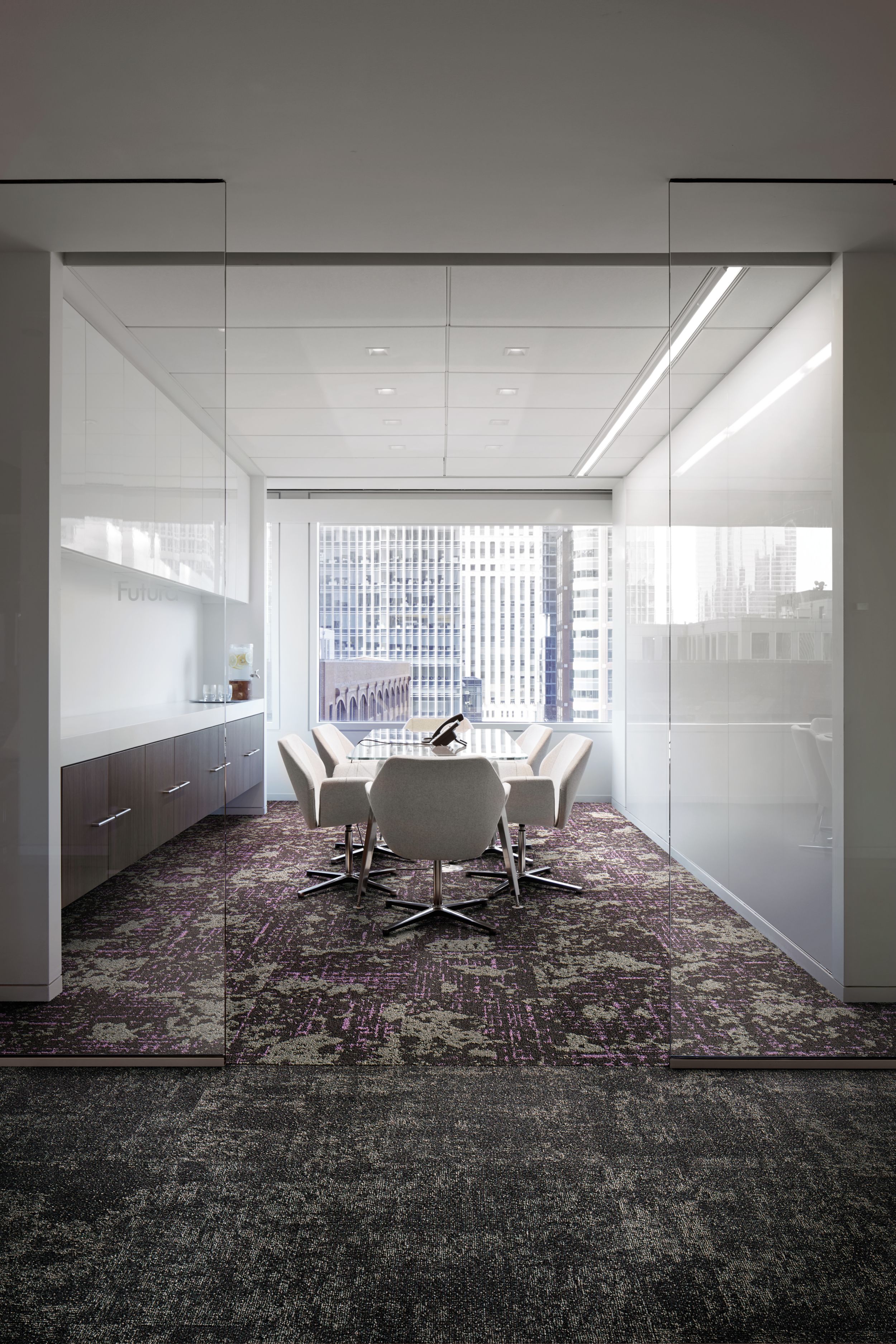 Interface Head in the Clouds carpet tile in meeting room with glass doorway and highrise buildings through window in the background image number 5