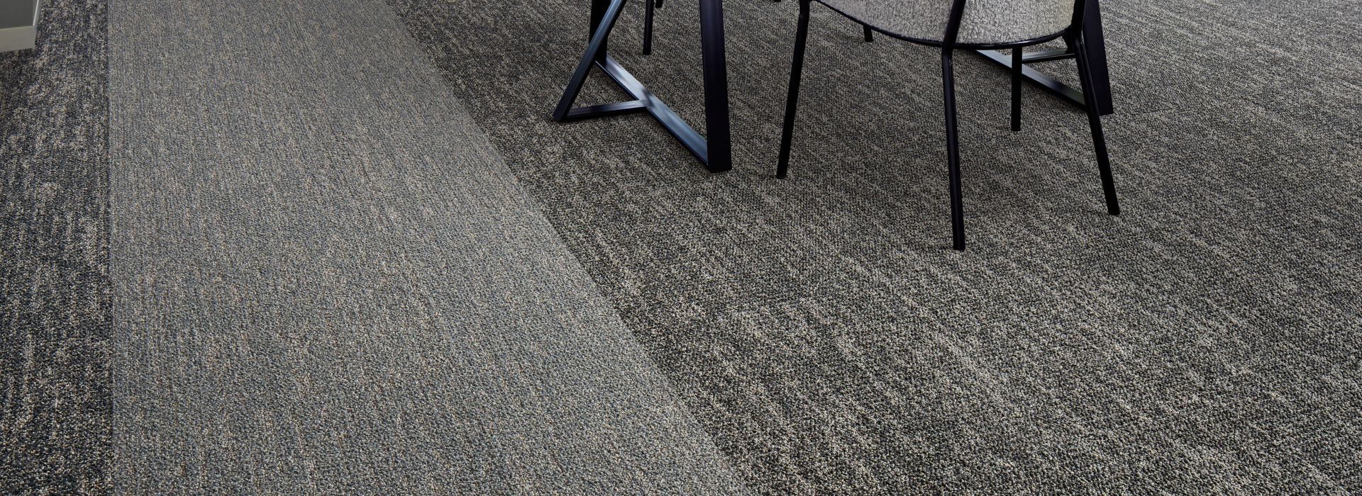 Interface Heart Strings carpet tile with desk and white flower chandelier overhead