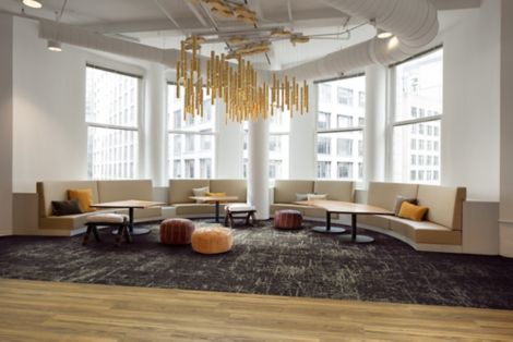 Interface Heartthrob carpet tile in common space with booths in half circle and high rise office building in background imagen número 3