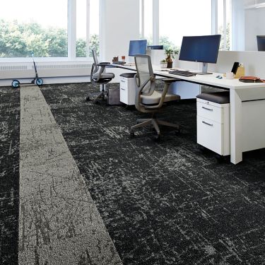 Interface Heartthrob carpet tile in multiple workspaces with computers on desks and scooter in background imagen número 1