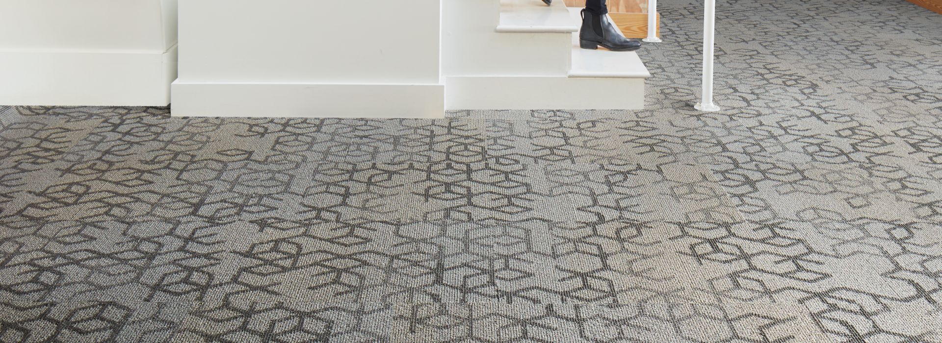 Interface Honey Do carpet tile with woman walking down open stairway and looking back
