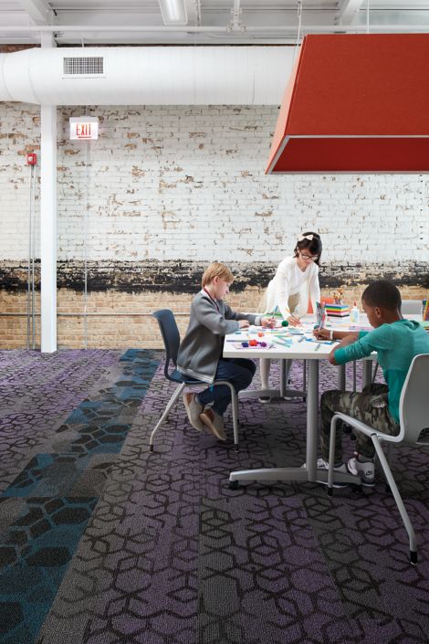 Interface Honey Do carpet tile with children playing and working at common table