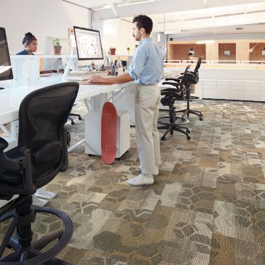 Interface Honey Don't carpet tiles with multiple standup workspaces with man working on computer image number 1