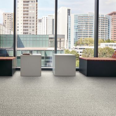 Interface Stitch in Time plank carpet tile with tables and chairs facing outside