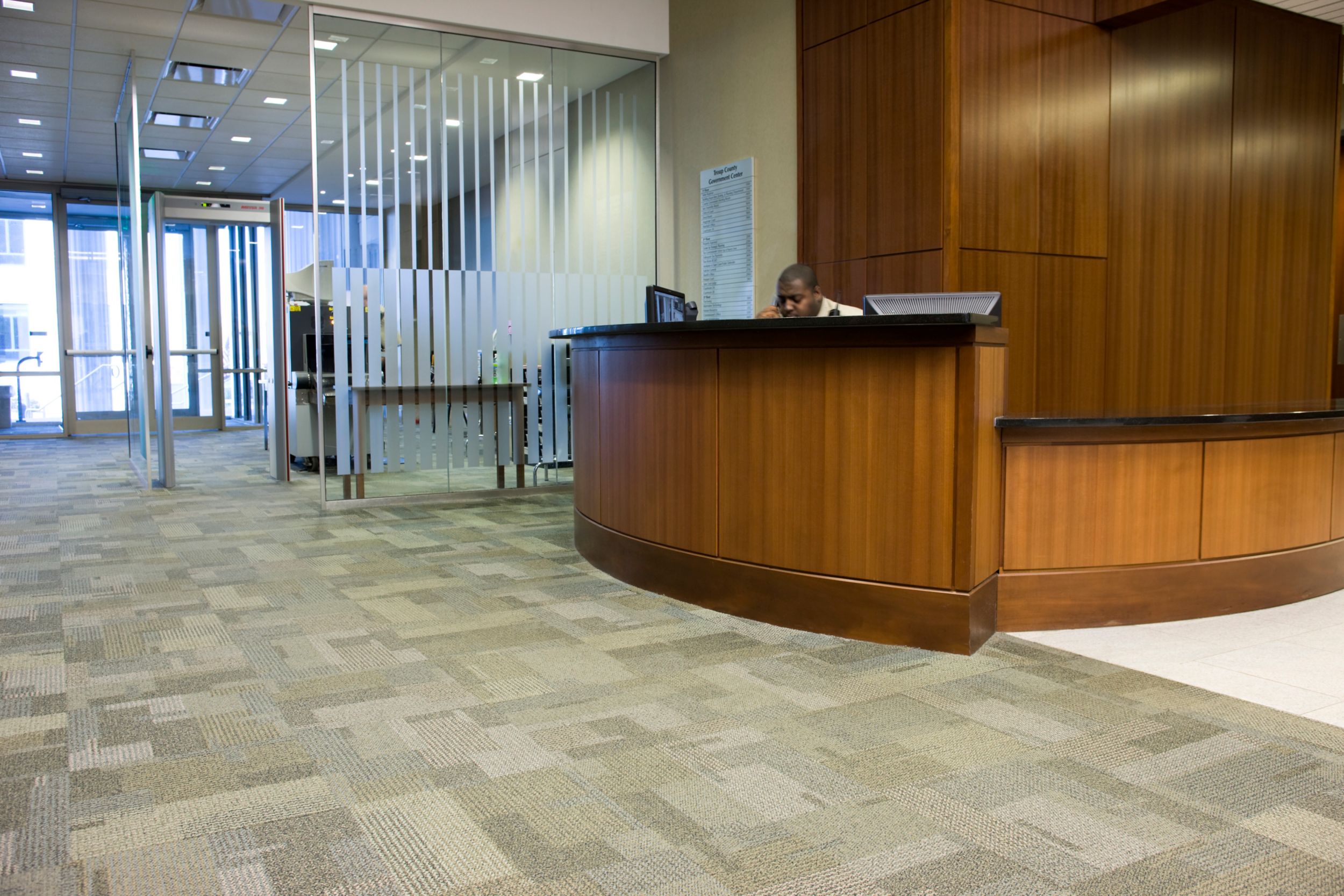 Interface Entropy carpet tile in front desk area with wooden wall and entryway in background image number 8