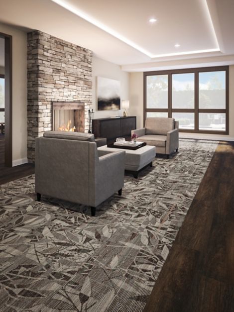 Interface Broadleaf carpet tile with Natural Woodgrains LVT in senior housing seatiing area with stone fireplace
