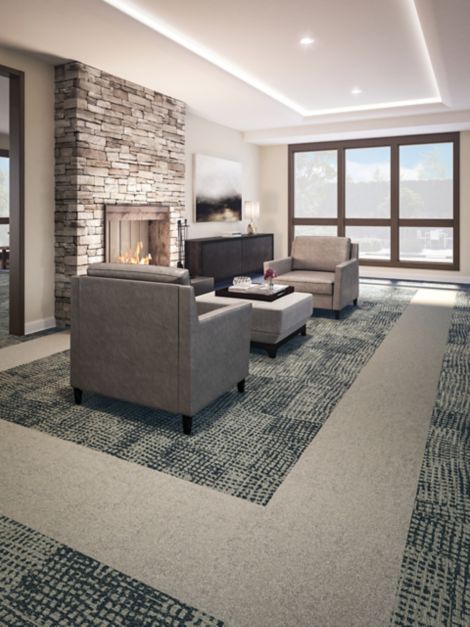 Interface GN160 and Shaded Pigment plank carpet tile in seating area with fireplace