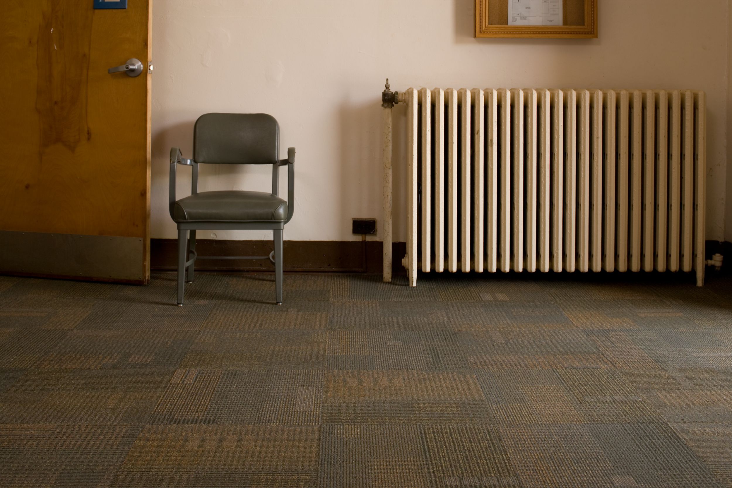 Interface Berlin, Syncopation and Menagerie II carpet tile in large room with wooden chair and radiator image number 7