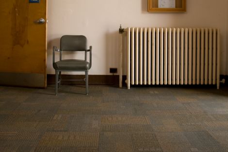 Interface Berlin, Syncopation and Menagerie II carpet tile in large room with wooden chair and radiator