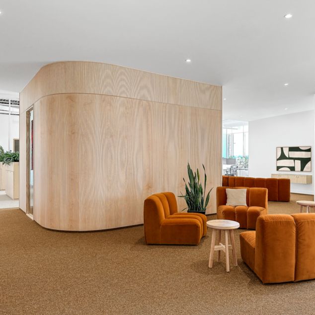 FLOR by Interface Industrious carpet tile in lobby setting with chairs and table