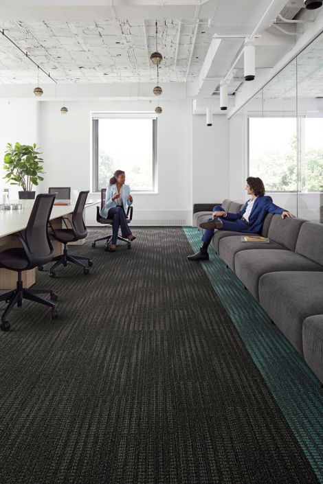 Interface Karmic Relief plank carpet tiles with man sitting on couch collaborating with woman in office chair image number 5