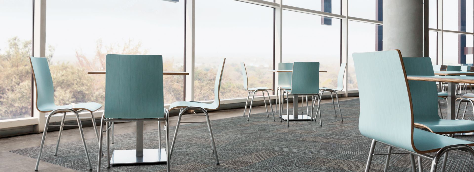 Interface Layout carpet tile and Textured Stones LVT in cafe area with teal colored chairs and natural light