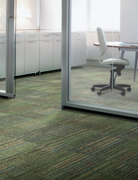 Interface Mantra carpet tile in meeting room with white cabinets and chairs with wooden table