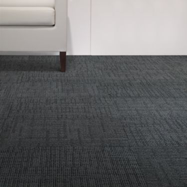 Interface Meet carpet tile in close up with light colored couch