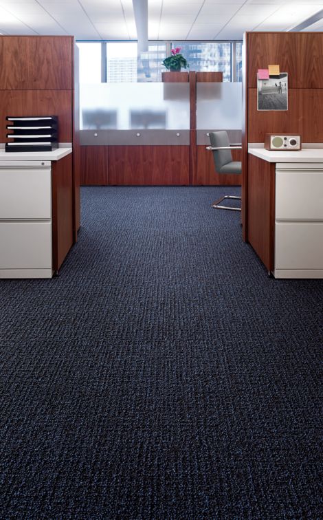 Interface Menagerie II carpet tile in office area with white cabinets and wooden cubicles