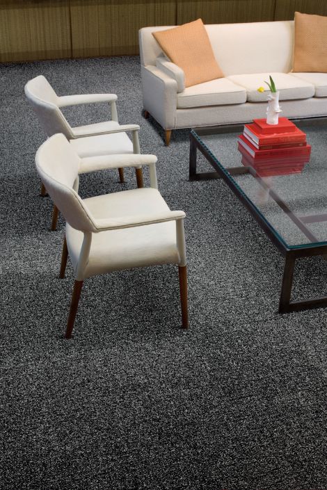 Interface Menagerie II carpet tile in seating area with white furniture and glass table