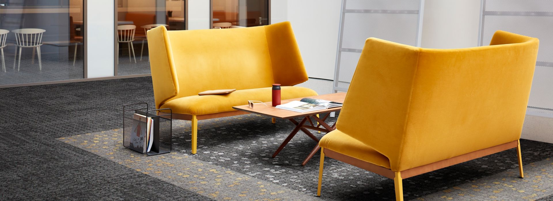 Interface Mercer Street and Broome Street carpet tile in seating area with two yellow couches