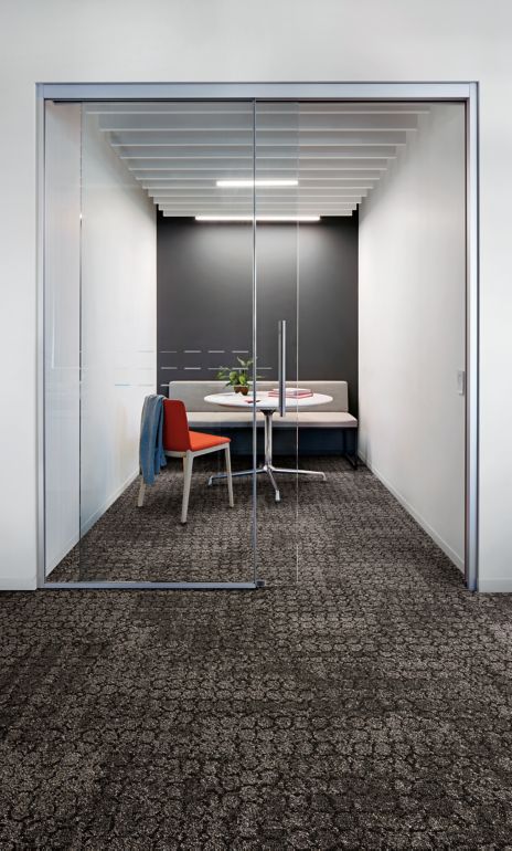 Interface Mercer Street carpet tile in seating room with sliding glass door