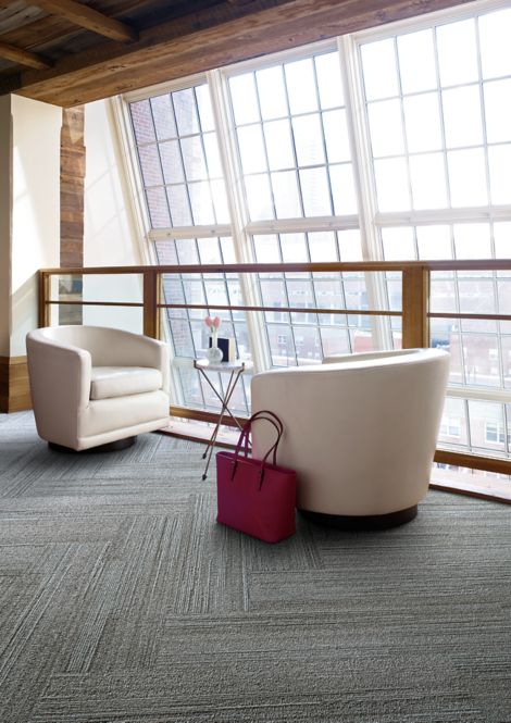 Interface NF400 plank carpet tile in seating area with white chairs