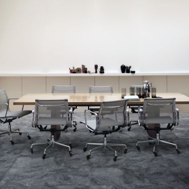 Interface Natural Stones LVT in a meeting room with conference table and chairs image number 1