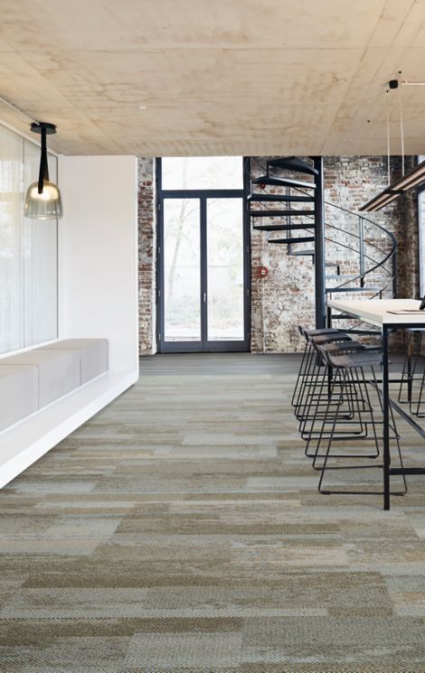 Interface Naturally Weathered plank carpet tile and Studio Set LVT in open office entryway with stairs and high top sitting area