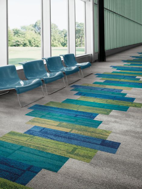 Interface Neighborhood Blocks and Neighborhood Smooth plank carpet tile in public corridor lobby with blue chairs