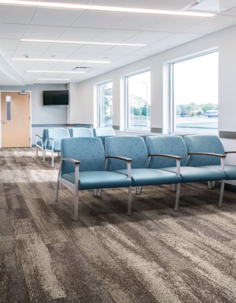 Interface Neighborhood Smooth plank carpet tile in waiting room with blue chairs