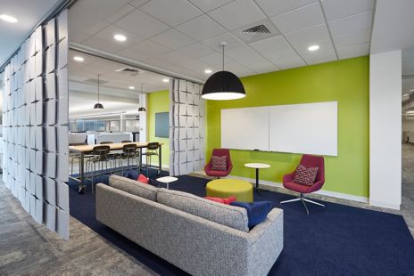 Interface HN830 in open workspace with lime green walls and privacy curtains