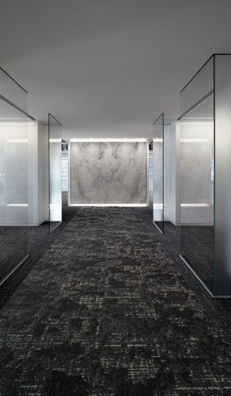 Interface Head in the Clouds carpet tile in corridor with glass walls on both sides