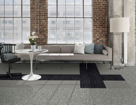 Interface Brownstone and WW890 plank carpet tile with Night Flight carpet tile in lounge area