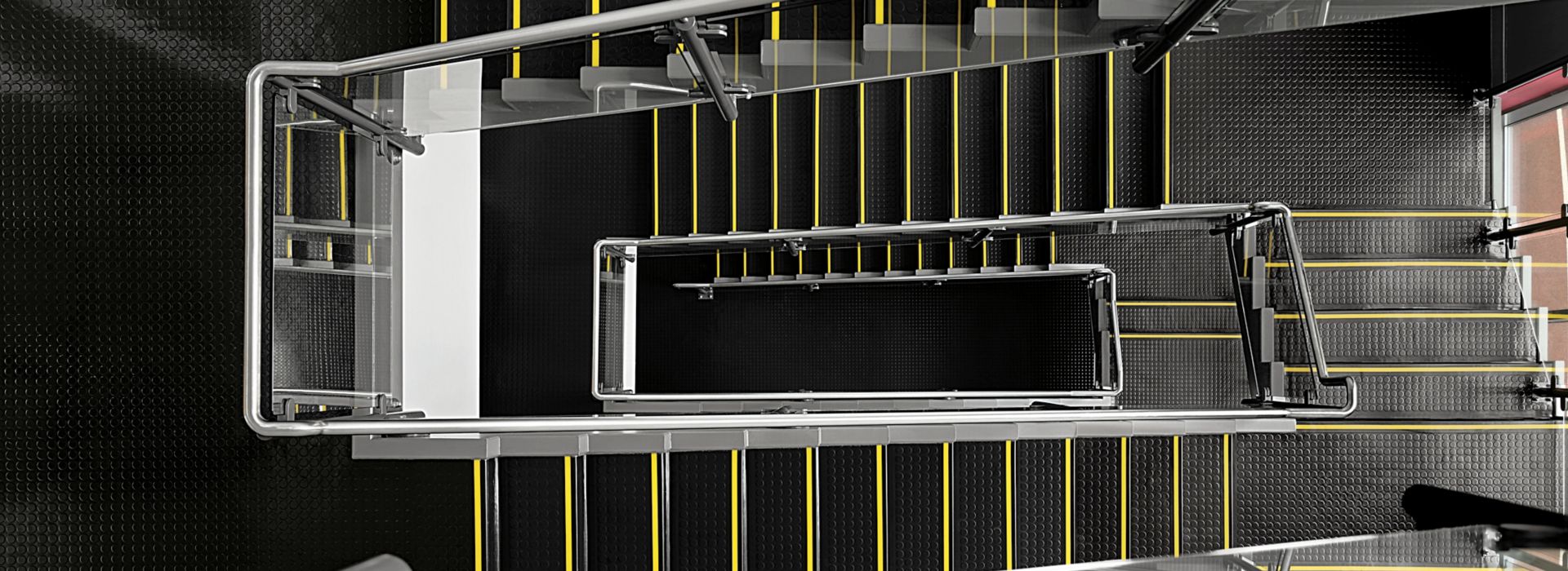 Staircase with norament 926 stairtread with safety stripes